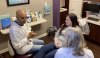 Fig 8. The patient is seated comfortably, facing forward, as the hygienist shares their and conversation and findings with the dentist.